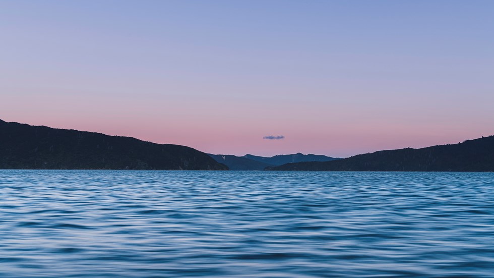 The Marlborough Sounds water, hills and full moon at sunset, Marlborough, New Zealand.