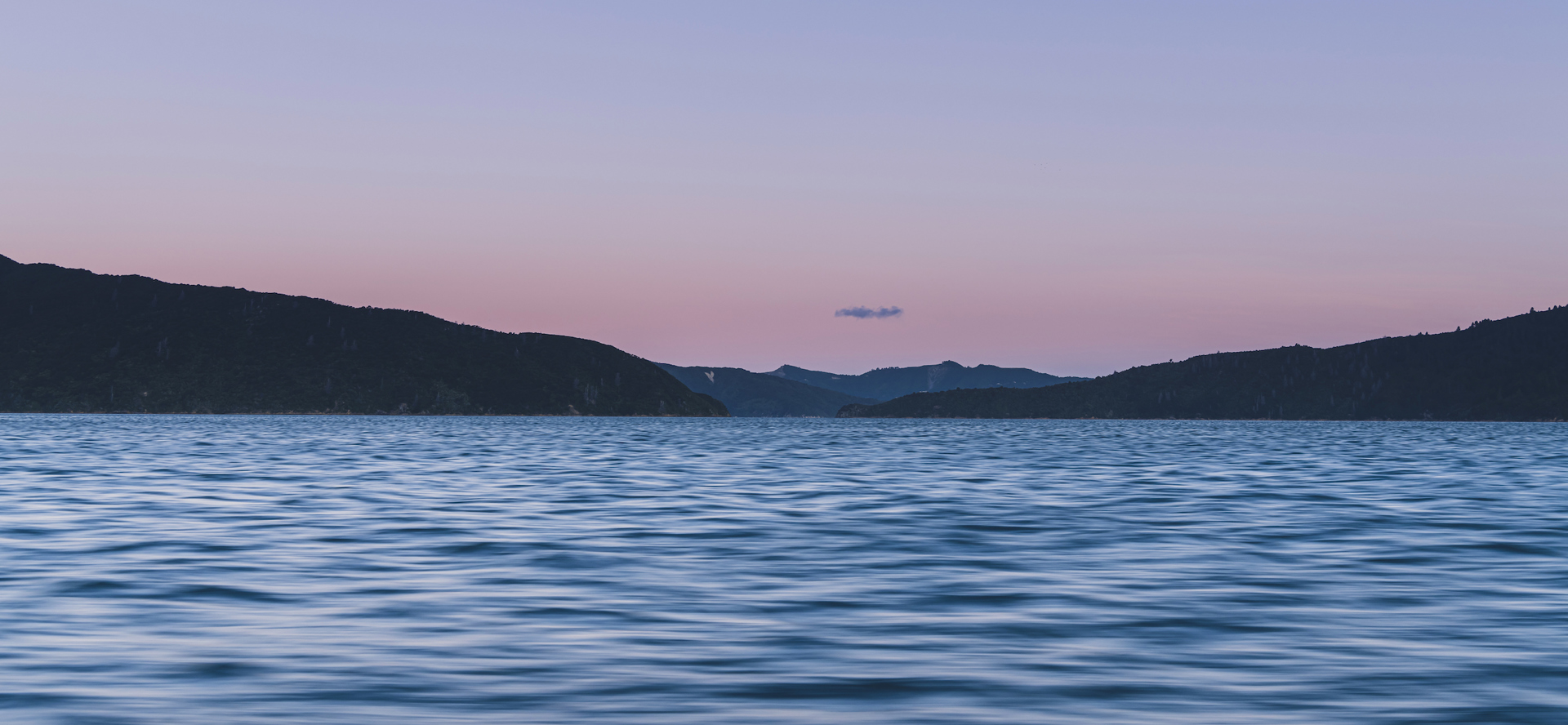 The Marlborough Sounds water, hills and full moon at sunset, Marlborough, New Zealand.