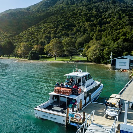 A Cougar Line boat tied up to the jetty at Furneaux Lodge in Endeavour Inlet, Marlborough Sounds, New Zealand.