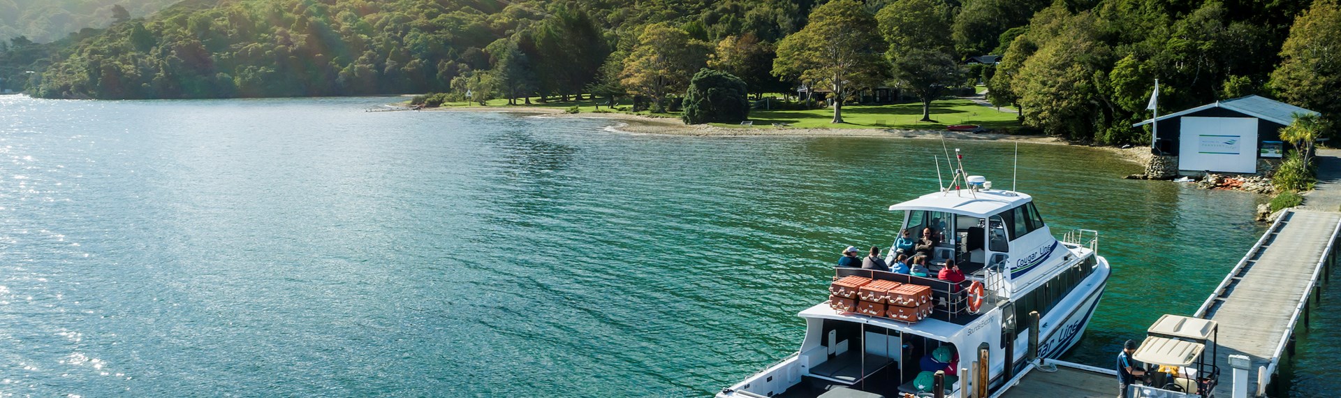 A Cougar Line boat tied up to the jetty at Furneaux Lodge in Endeavour Inlet, Marlborough Sounds, New Zealand.