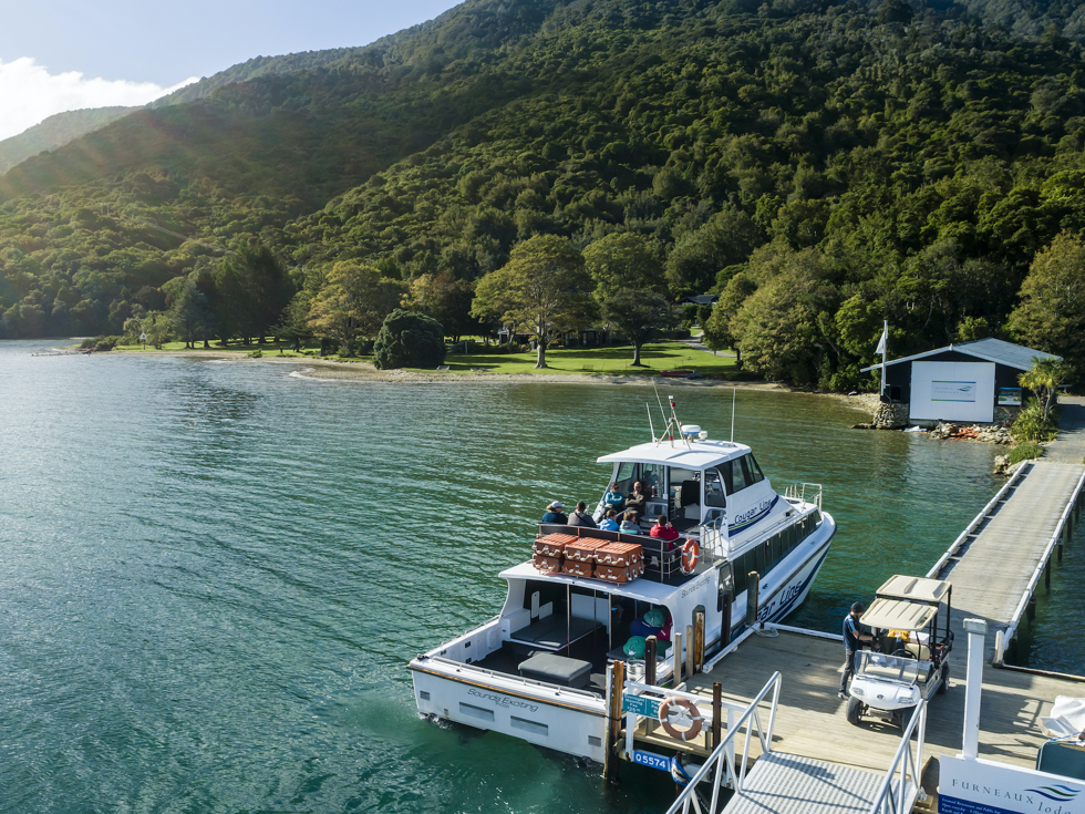 A Cougar Line boat tied up to the jetty at Furneaux Lodge in Endeavour Inlet, Marlborough Sounds, New Zealand.
