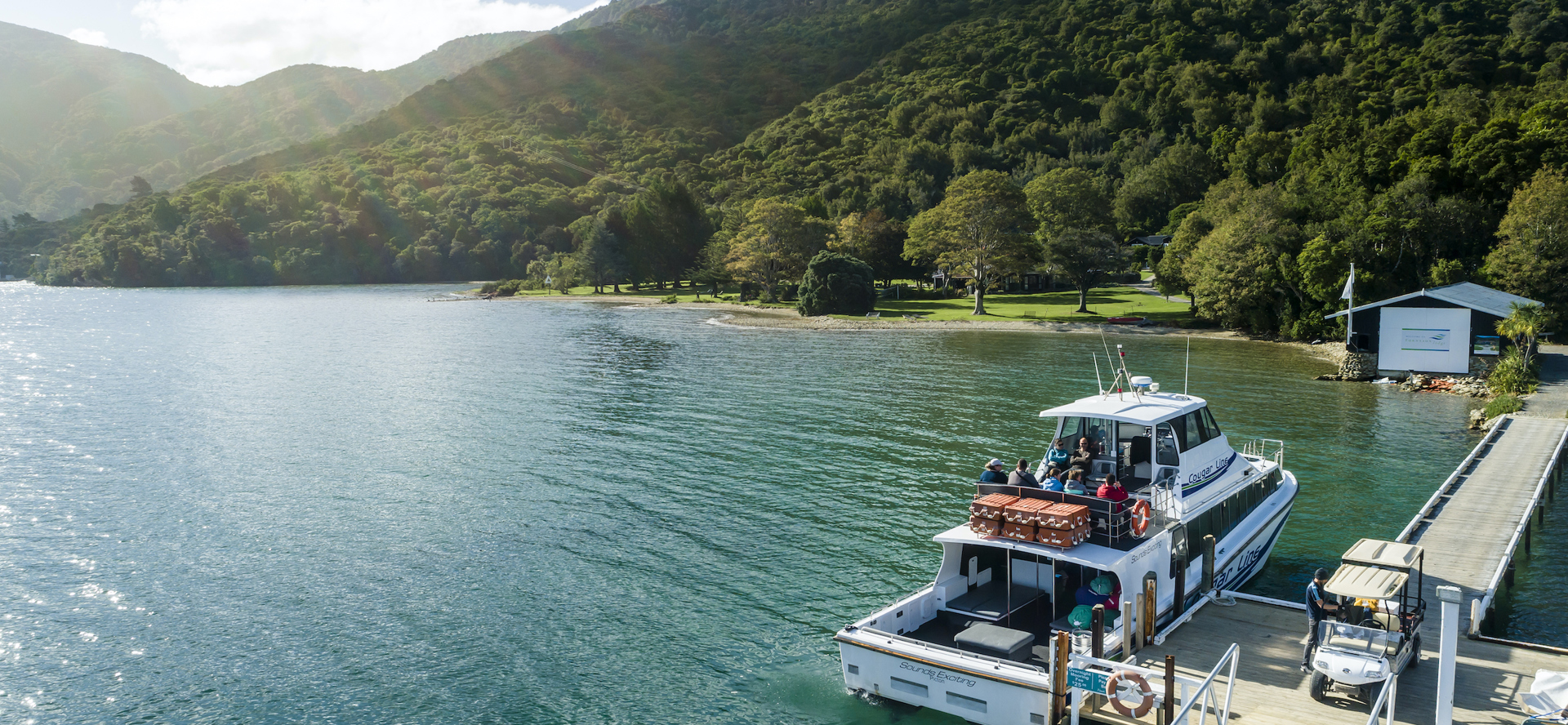A Cougar Line boat tied up to the jetty at Furneaux Lodge in Endeavour Inlet, Marlborough Sounds, New Zealand.