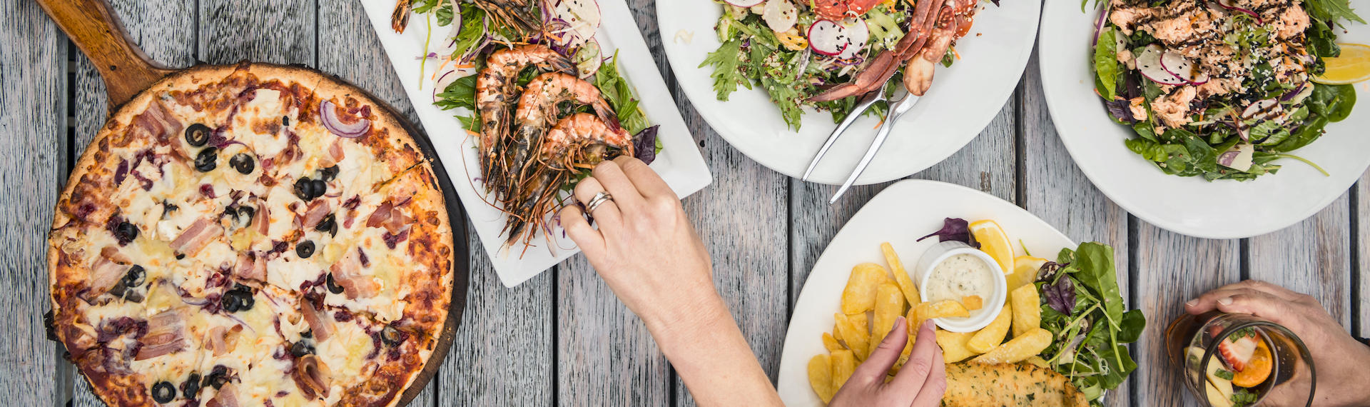 A selection of stone-baked pizza, local seafood and other dishes at Punga Cove in the Marlborough Sounds, New Zealand.