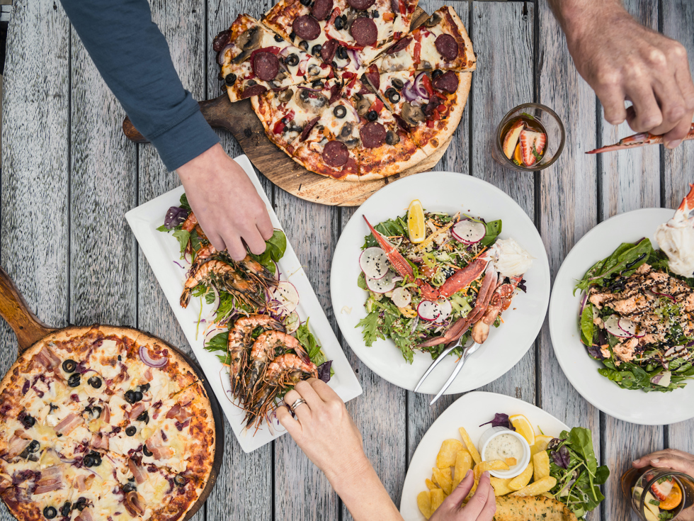 A selection of stone-baked pizza, local seafood and other dishes at Punga Cove in the Marlborough Sounds, New Zealand.