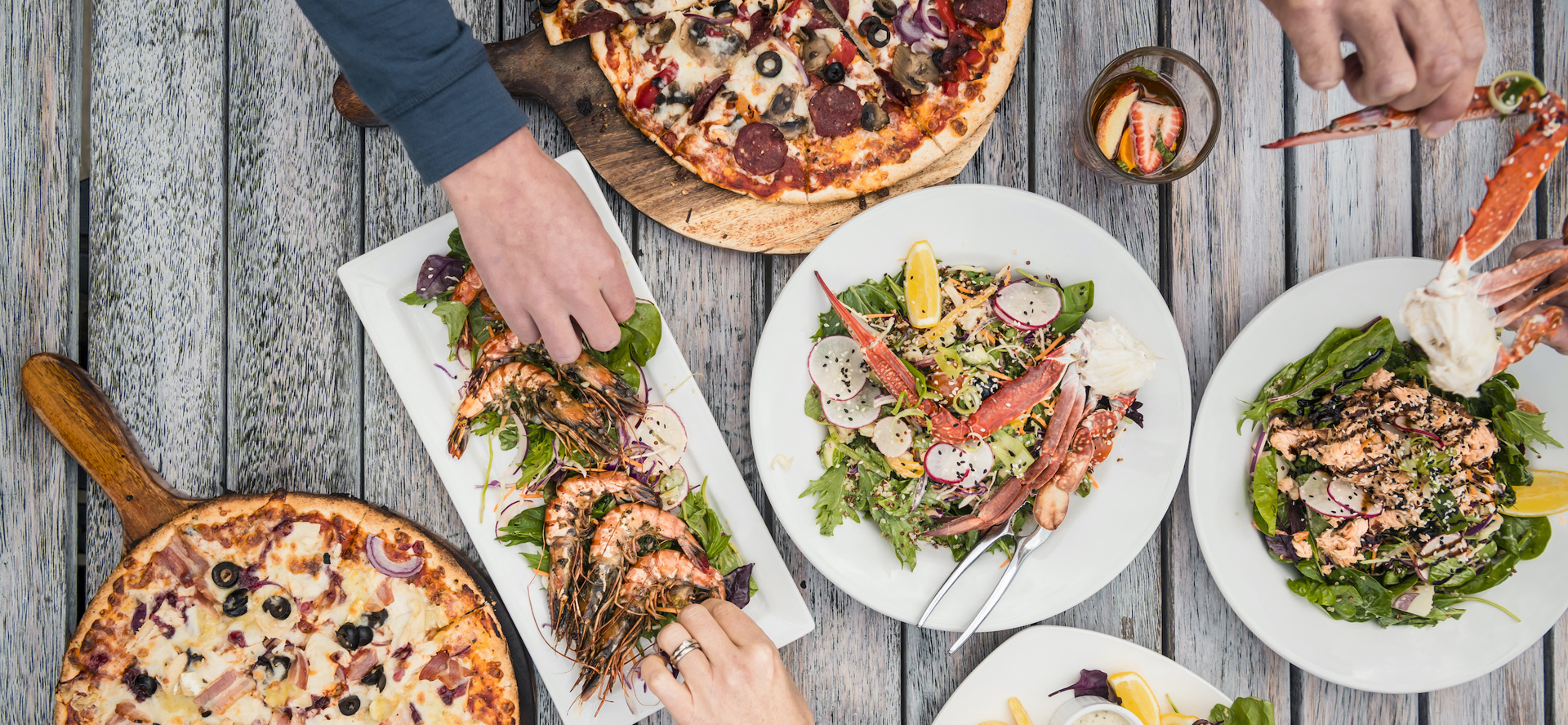 A selection of stone-baked pizza, local seafood and other dishes at Punga Cove in the Marlborough Sounds, New Zealand.