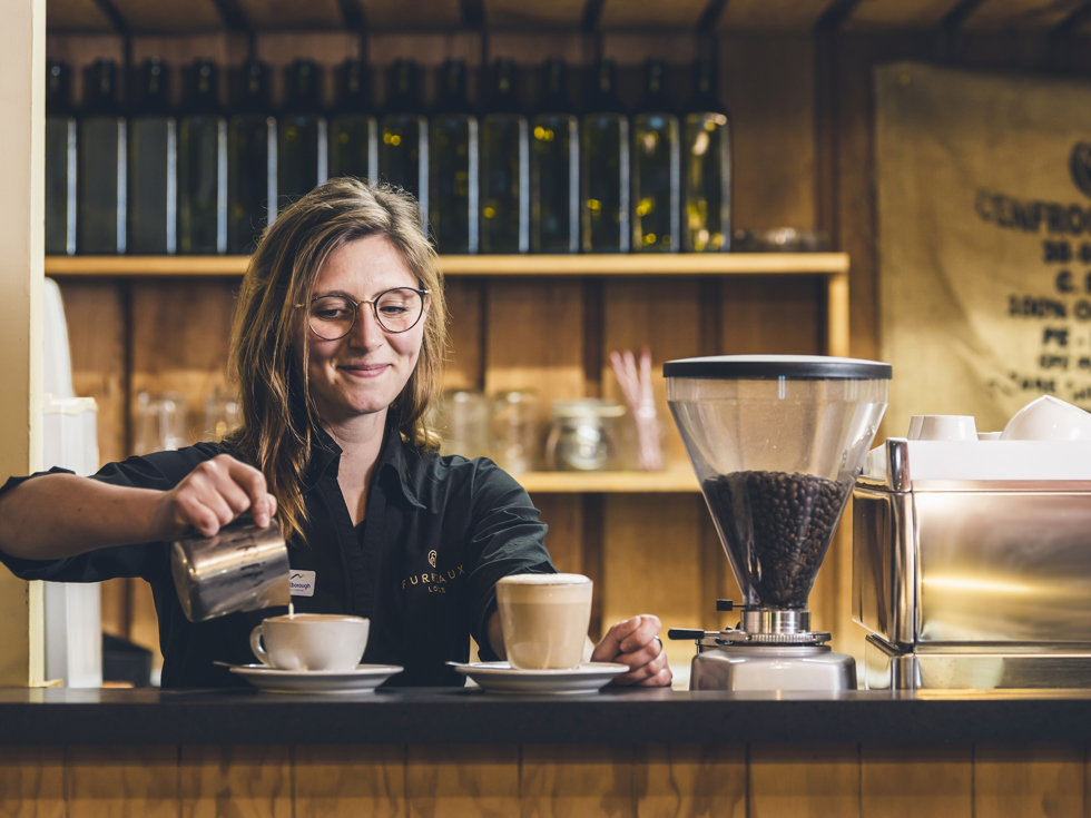 A barista makes coffee at Furneaux Lodge in the Marlborough Sounds, New Zealand.