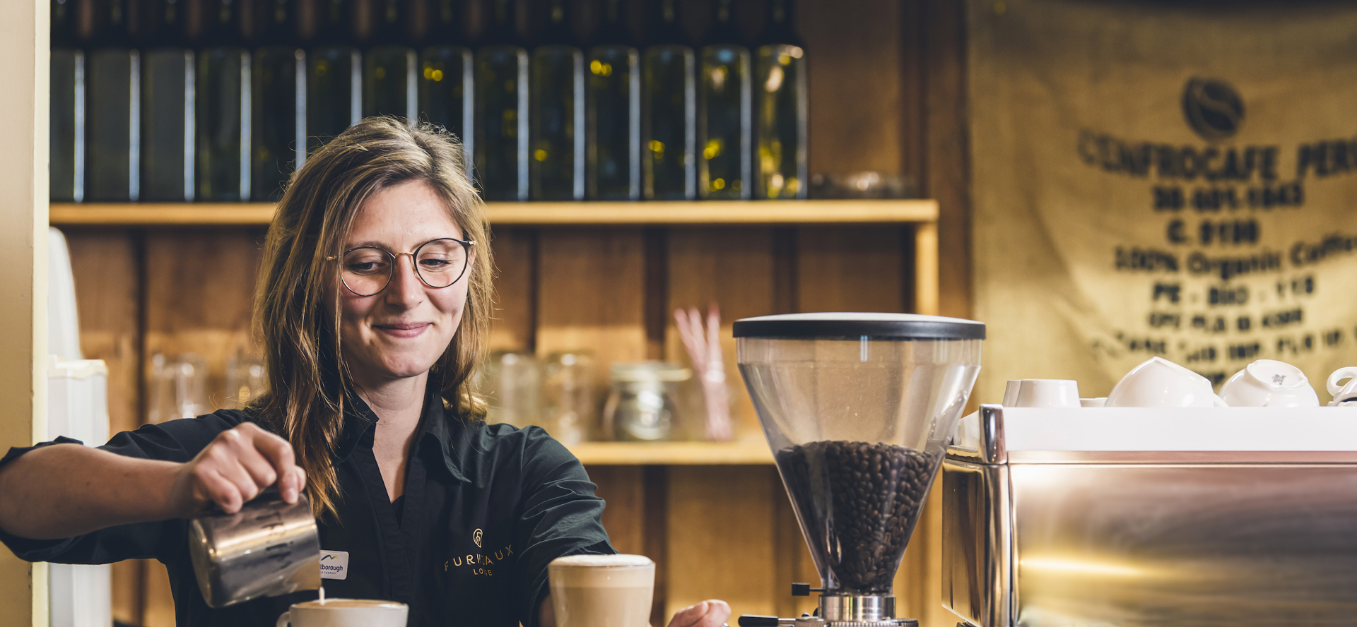 A barista makes coffee at Furneaux Lodge in the Marlborough Sounds, New Zealand.