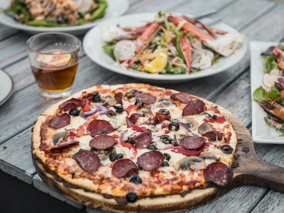 Fresh stone-baked pizza served at Punga Cove in the Marlborough Sounds, New Zealand.