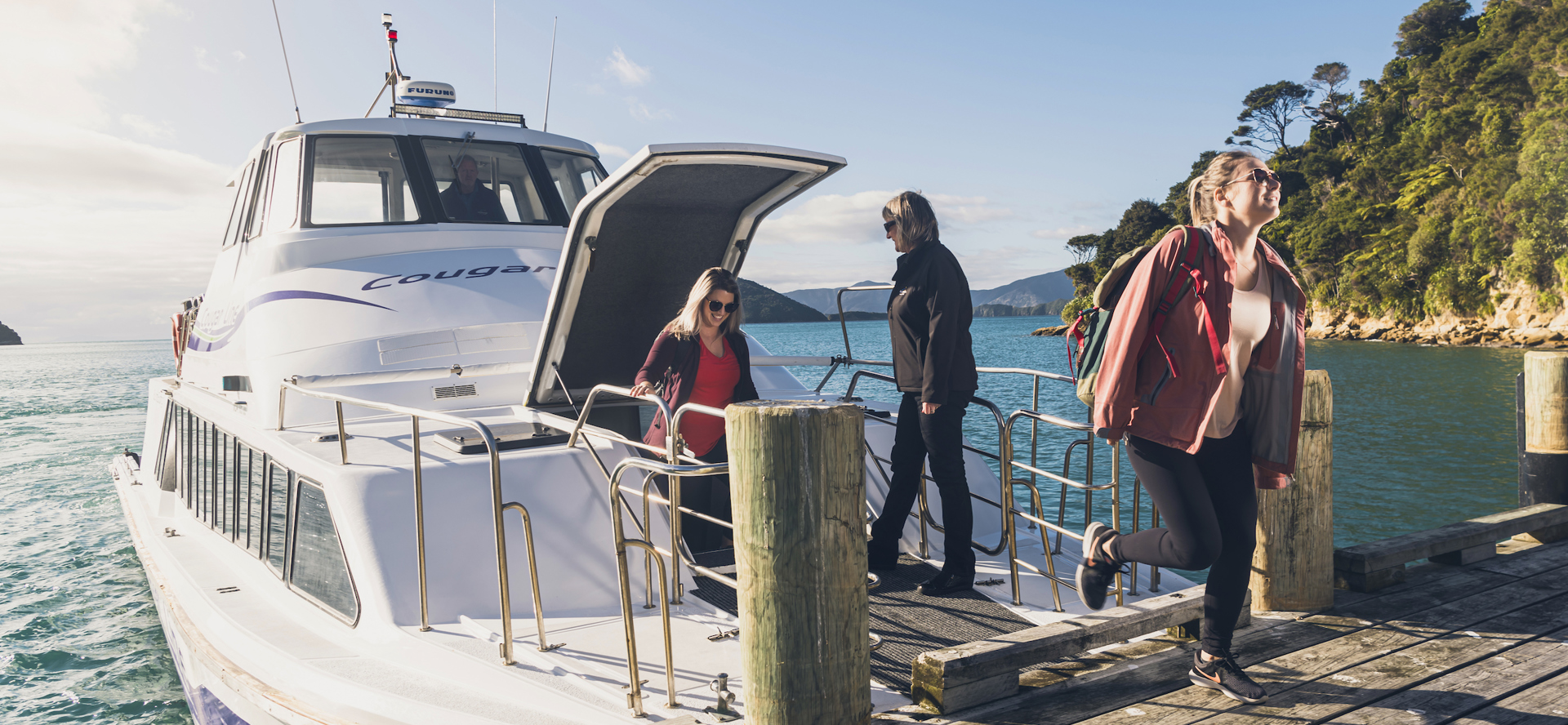 Cougar Line passengers disembark the boat at Ship Cove/Meretoto to start the Queen Charlotte Track in the Marlborough Sounds, New Zealand.