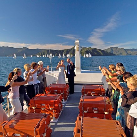 A newly married couple celebrate their wedding in the Marlborough Sounds aboard a Cougar Line boat.
